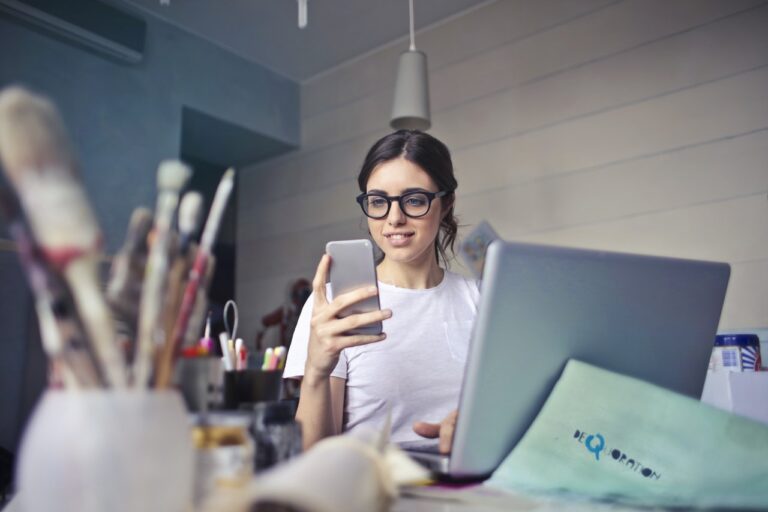 Girl reading CreativeCut blog on mobile phone